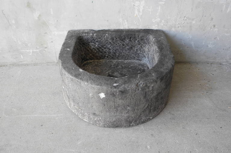 This 18th century Belgian Blue stone sink originally rested in a village house near Brugges, Belgium. It's unique shape would be an excellent addition to a powder bath. 

Bowl depth: 5.75