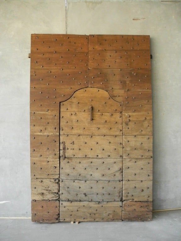 These 17th century Tuscan Walnut entrance doors originally guarded the front of a Villa near Arezzo, Italy. They are truly exquisite in their history. From their design to their original antique hardware, it is obvious how old and rich this piece