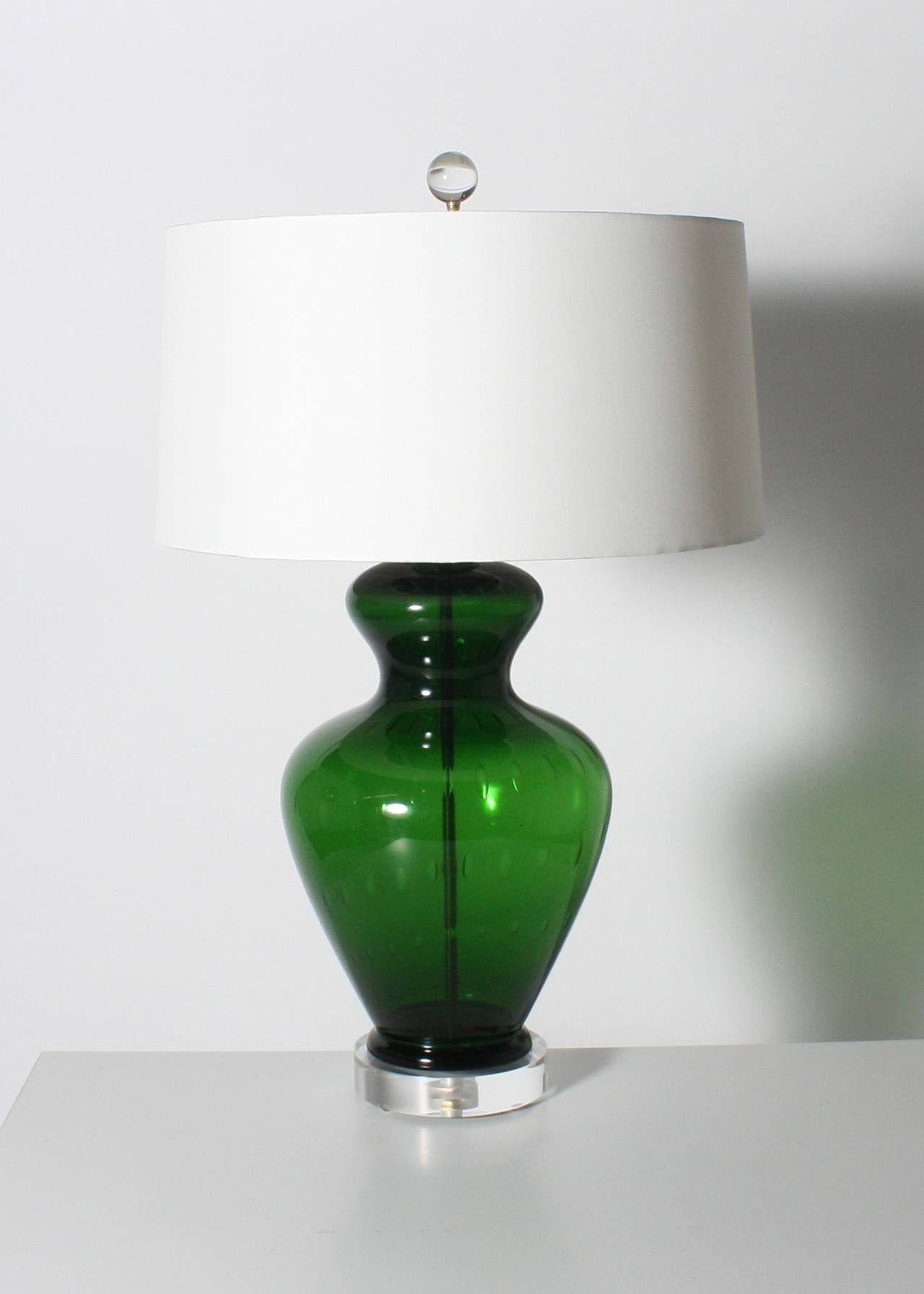 Pair of green Barovier lamps with large bullicante inclusions. Linen shades rolled with no bias. Three-way socket, 50/100/150 watt. Brass hardware. Lucite base. Crystal ball finial. Gold twisted cording.