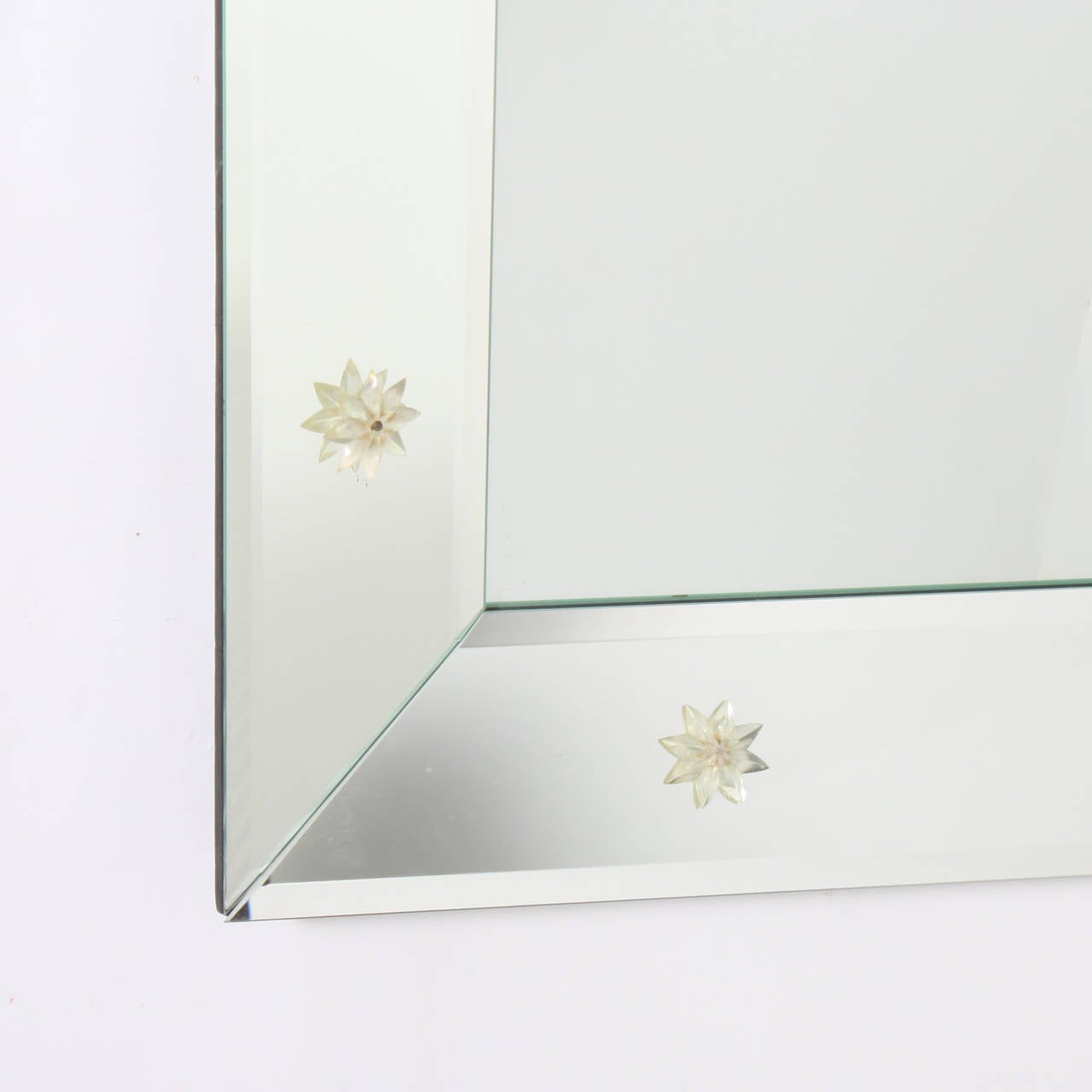 French beveled mirror frame mirror with rosettes.