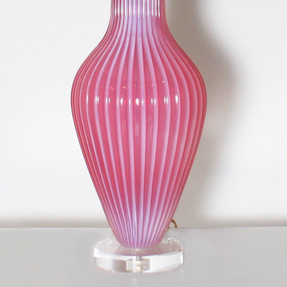 Large pink opaline ribbed Murano glass lamp. Off-white pongee shade. 3 way socket, 50/100/150 watt. Nickel hardware. Lucite base. Crystal ball finial. Silver twisted cording. 