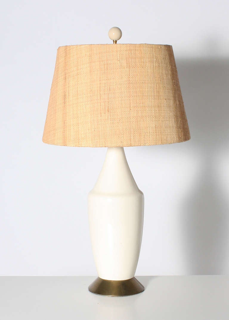 Pair of white ceramic lamps with bronze base and raffia shades