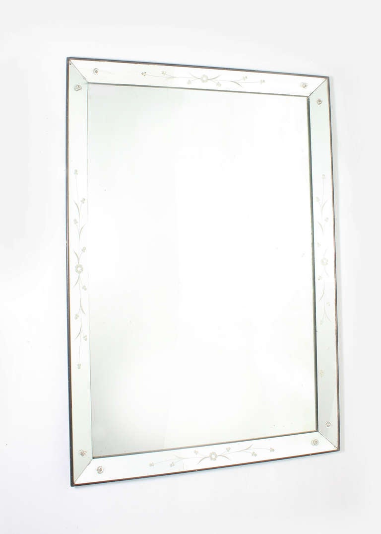 French mirror frame mirror with flower motif and glass flower rosettes. Straight edge mirror with thin outside frame. Slight antiquing and cloudy on inner mirror. Mirror can be hung both vertical and horizontal. 