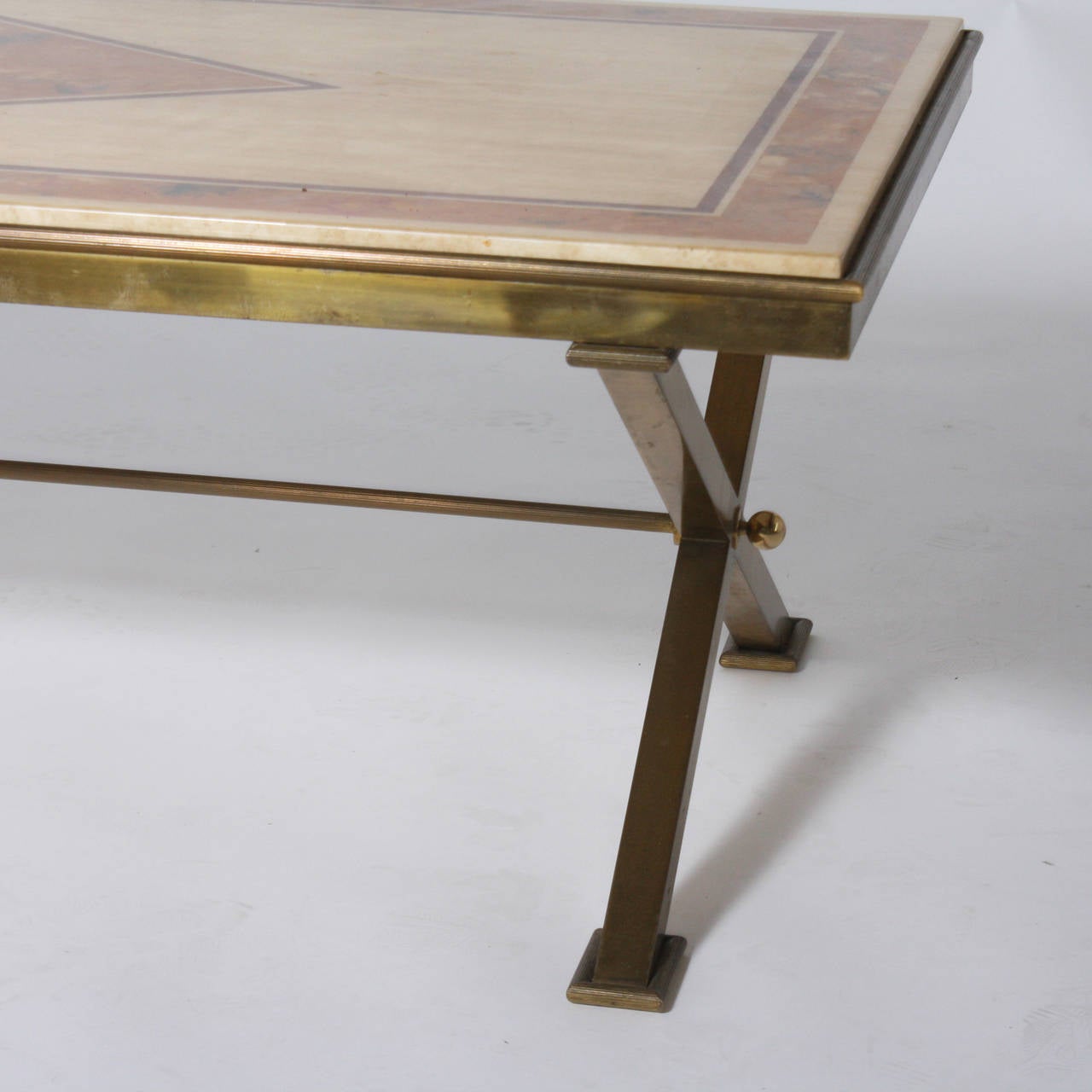 Bronze x-base coffee table with travertine top and faux marble by Jansen.