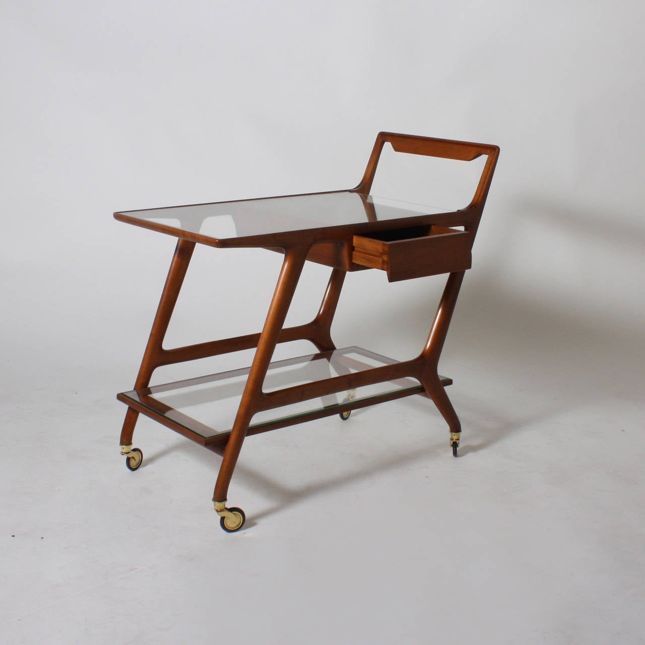 Mid-century maple bar cart with small drawer which pulls out on one side of the cart. Minor surface scratches on New brass and rubber wheels made to look vintage. 