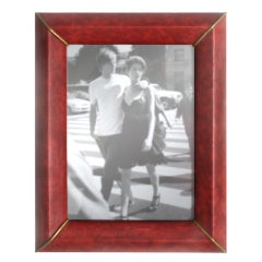 Red faux leather frame with brass accents at corners, c. 1950
