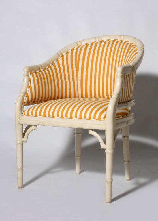 Pair of faux bamboo barrel chairs in antique French Ivory with yellow and ivory striped upholstery