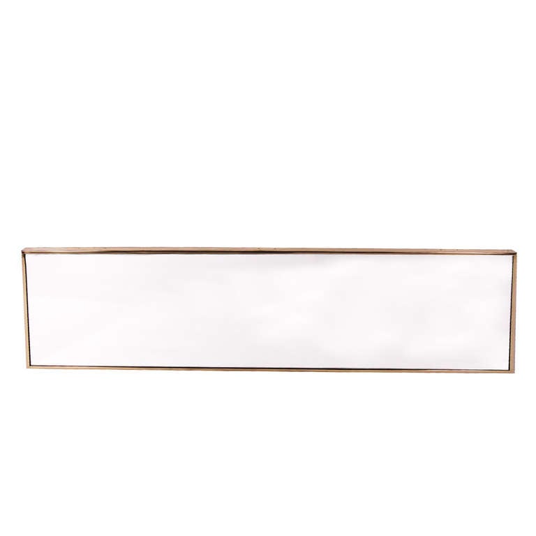 Brass frame around mirrored front. Can be hung either vertically or horizontally.  Marked with retailer from Chicago.