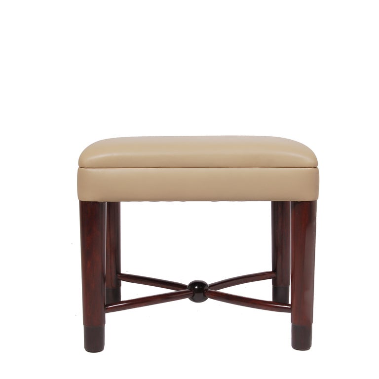 Rare occasional or vanity stool, mahogany stained wood base with ebonized ends and new leather seat. Made by Cavalier.