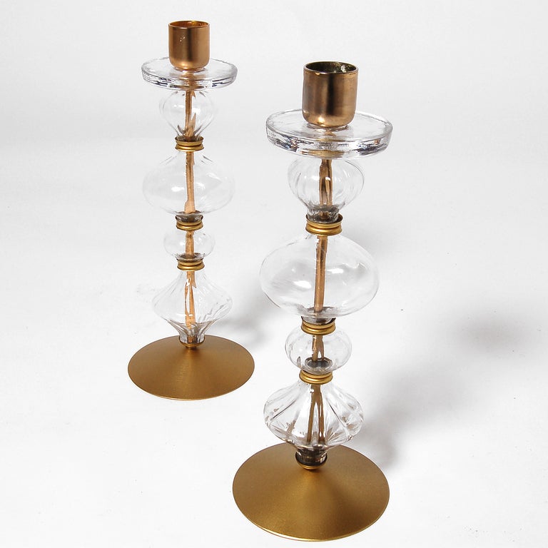 Pair of crystal candlesticks with brass candle holder, connectors, rod and base. Signed at bottom. Made by Boda.