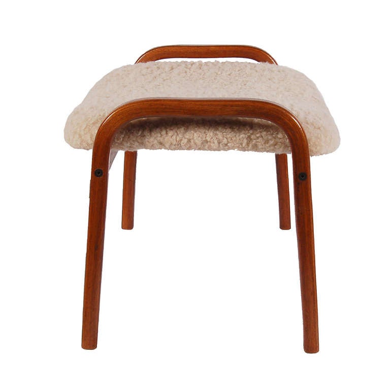Ottoman used with Lamino lounge chair or as individual occasional extra seating; teak laminated plywood frame with sheepskin upholstery. Made by Swedese.
