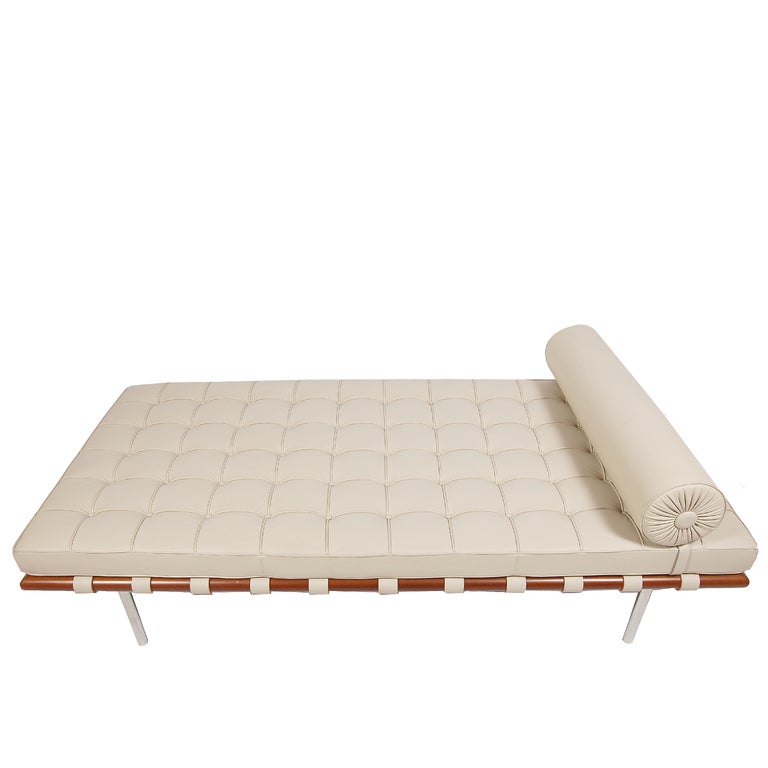 Classic daybed with individually sewn squares of light taupe leather with removable head roll on wood frame with round stainless steel legs. Marked on base with 