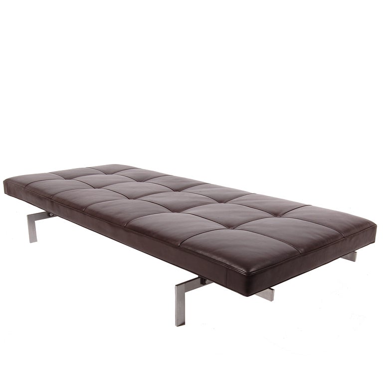 Daybed/bench with black/brown leather upholstered cushion on flat, angular matte chrome steel frame. Dated label on base, made by Fritz Hansen 1985.