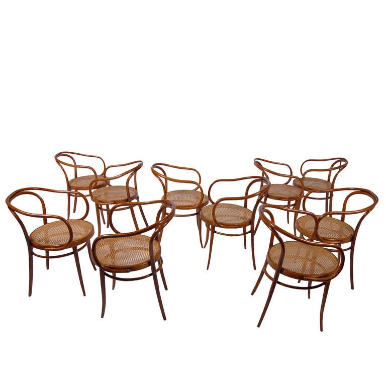 Ten bent, solid and laminated beech with woven cane seat armchairs. Classic Thonet design, used by Le Corbusier in his Pavillon de l'Esprit Nouveau at the Paris Exhibition of 1925. Stamped 