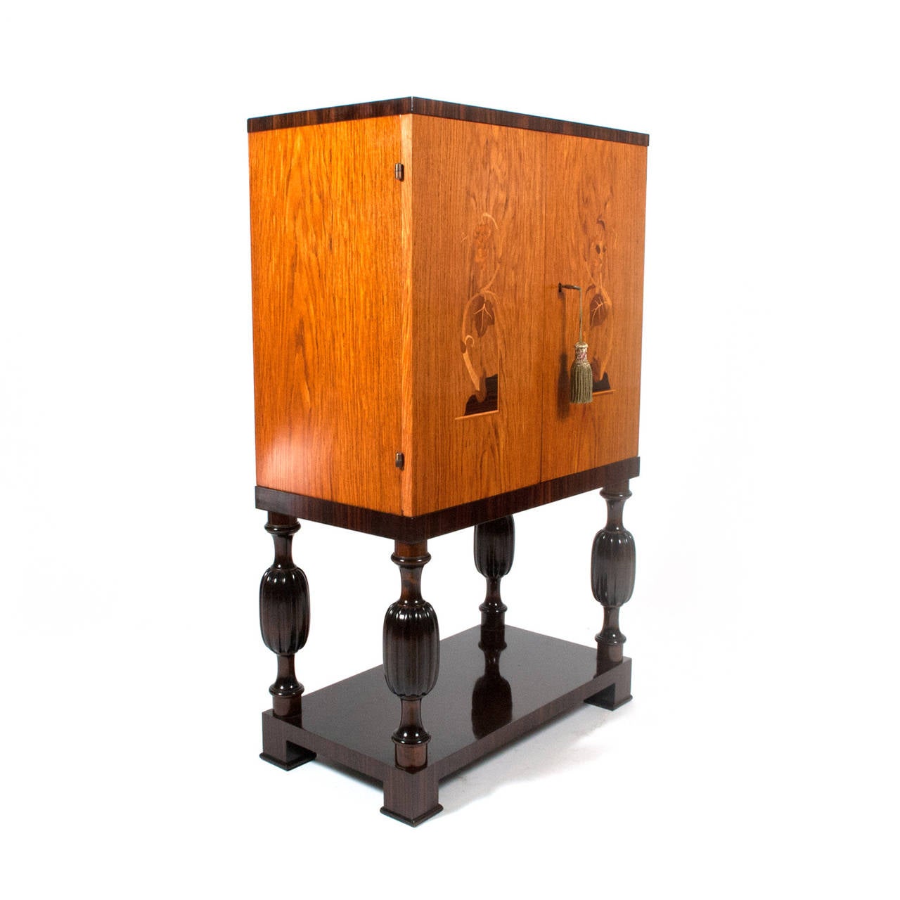 Original condition two-door inlay cabinet with various exotic woods, shelves and two drawers in mahogany, legs and shelf below dark stain birchwood.