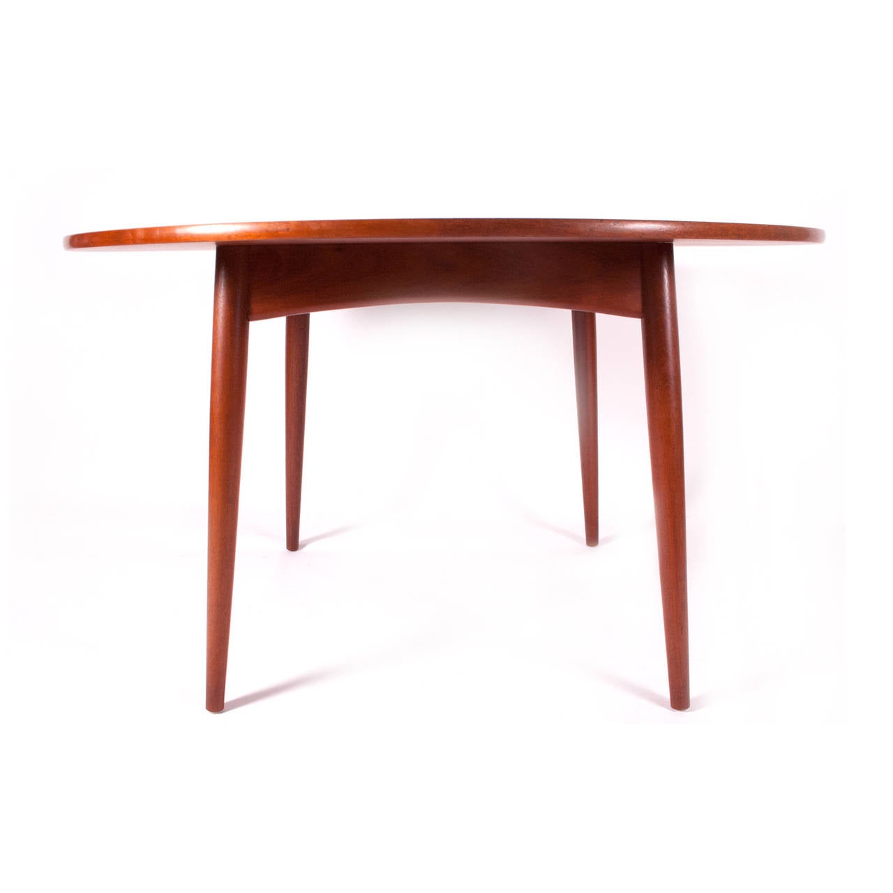 Simple round teak dining table design by Hans Wegner for Andreas Tuck, Denmark impress in wood, custom pads included, removable legs for shipping.