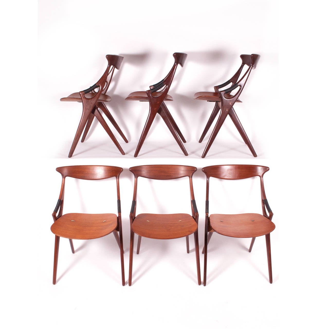 Solid teak chairs with plastic wrapped plywood seat arms with brass detail. Made by Mogens Kold, 1959.