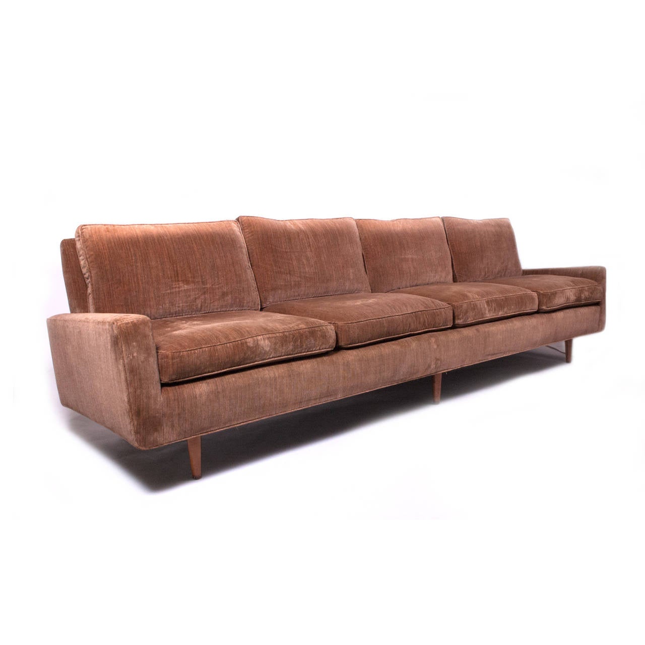 Custom size four-seat sofa on tapered stained birch cone legs. Down cushions. Upholstered in velour. Retains dated label from feather company and model number. Made by Knoll Associates.