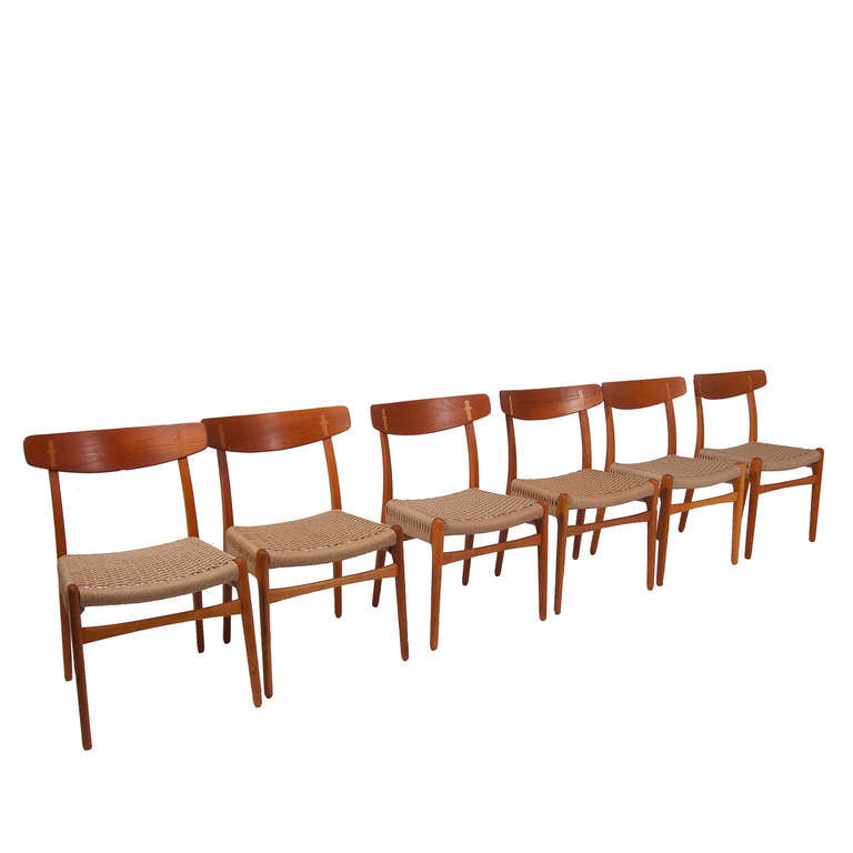Original production of Wegner's famous dining chairs, with teak back and oak frame; new Danish rope seats.  Made by Carl Hansen and Son.