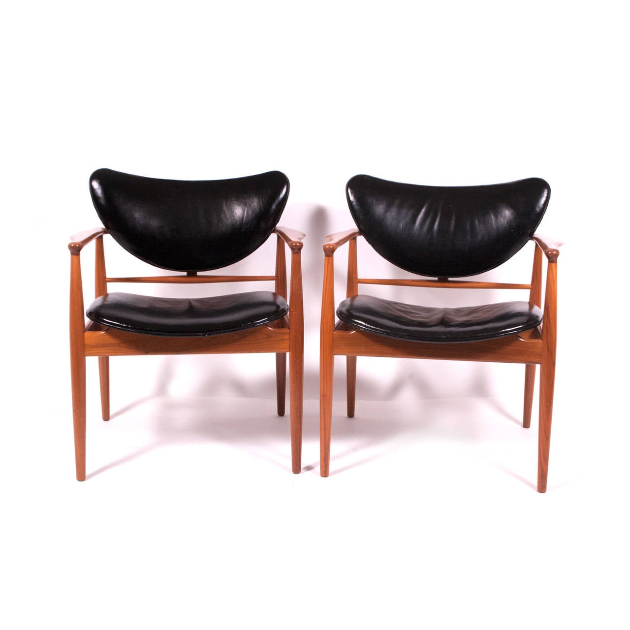 Pair of Finn Juhl armchair for Baker in original condition. Solid walnut and original leather upholstery. Early 1950s production.