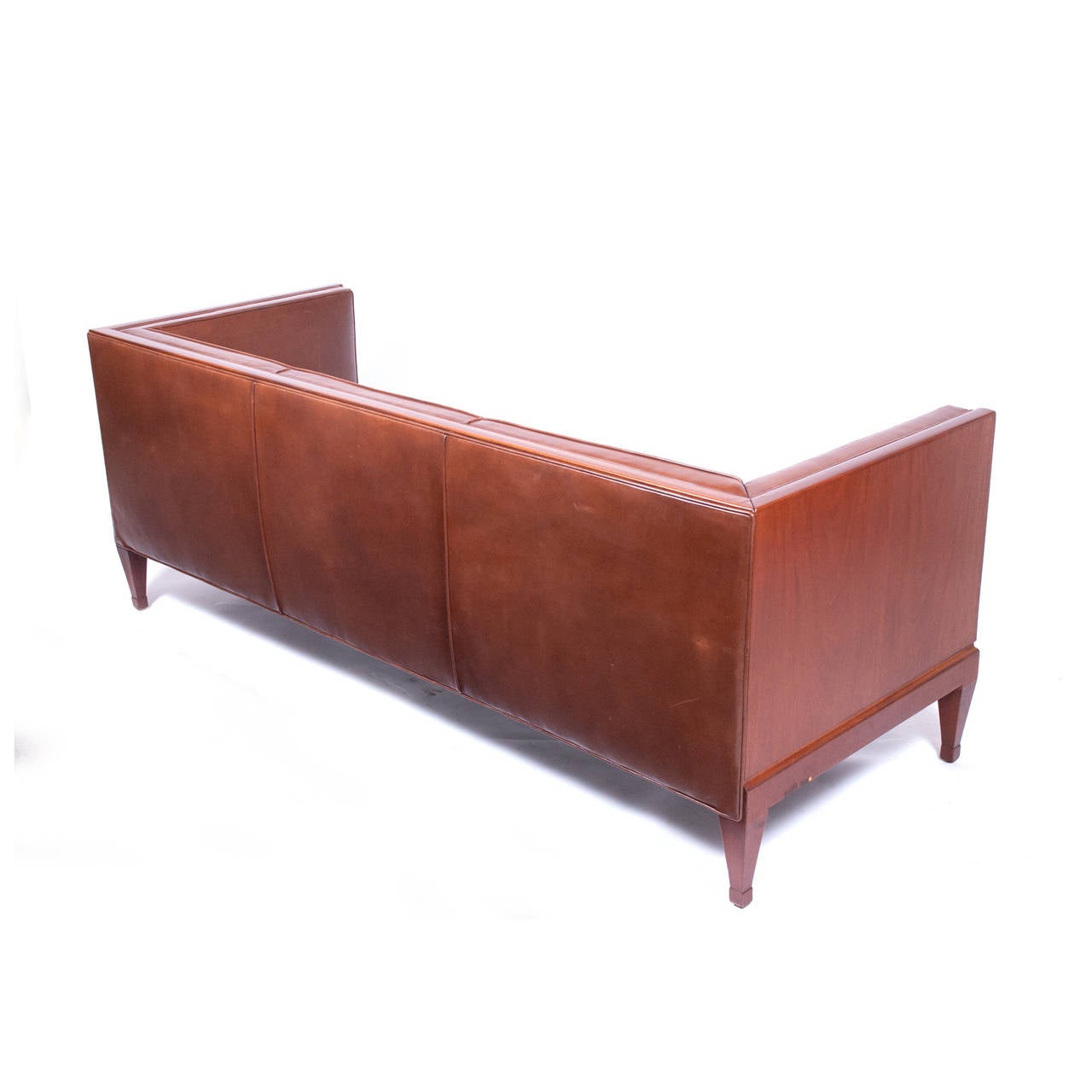 Rare mahogany sofa design and manufacture by Frits Henningsen in 1930s, newer leather upholstery custom upholstery in the back of the sofa.