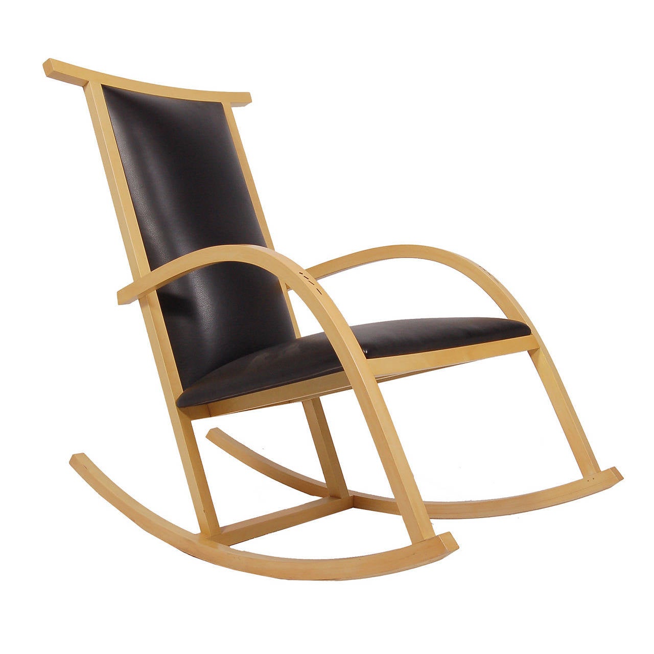 Solid sycamore frame with ebony inlays in arms and top rail.
Upholstered in black leather. Designed by Riart, a Barcelona native, to commemorate the 50th anniversary of the Barcelona chair. This piece was a showroom sample, never used. Made by