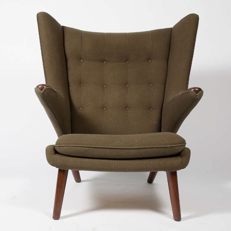 Iconic lounge chair by Wegner, with solid rosewood arm pads and solid stained beech legs.  Previously reupholstered with Kvadrat Danish wool fabric.
Retains label from retail seller.  Made by A.P. Stolen.