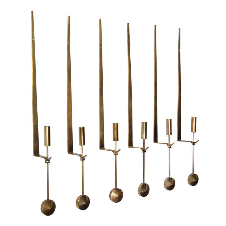 Six brass wall mounted candleholders, made by Skultuna, Sweden.
Signed with artist name and manufacturer's mark.