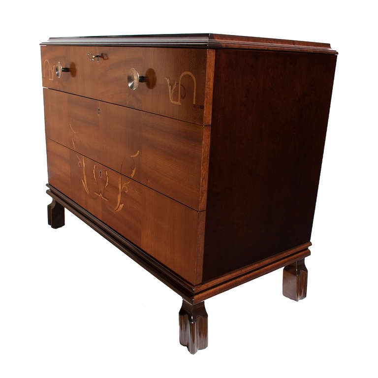 Three drawer chest, with mahogany drawers and stained birch case, top and legs.  Fruitwood inlay decoration with round steel handles.  Dated 26 March, 1942 inside drawers. With original key.