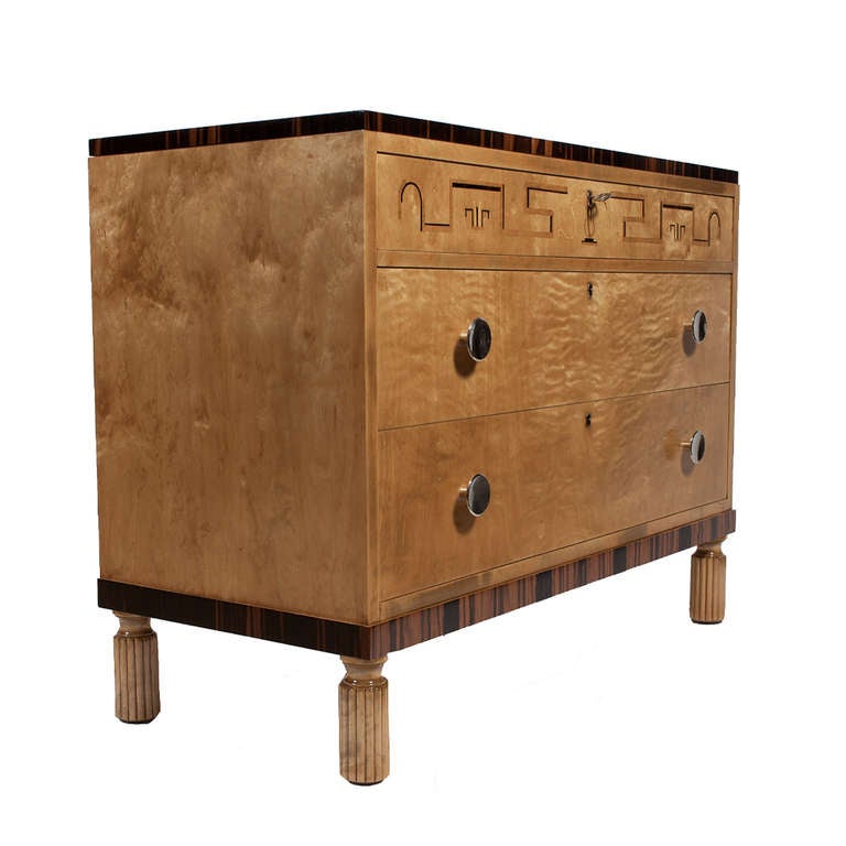 Three drawer chest, birch with ebony trim on fluted legs.  Ebony and fruitwood inlay decoration.  Metal pulls.  Retains original key.