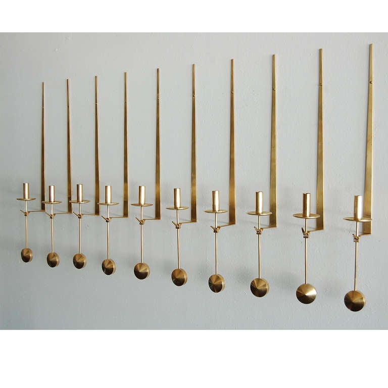 Ten brass wall mounted candleholders, made by Skultuna, Sweden.
Signed with artist name and manufacturer's mark.
