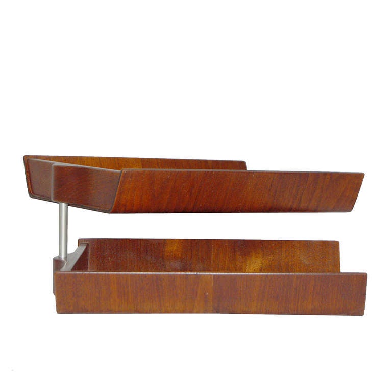 Molded teak plywood pivoting double letter tray, stainless steel pin separates the two trays.  Felt feet on bottom. Retains original label to bottom.