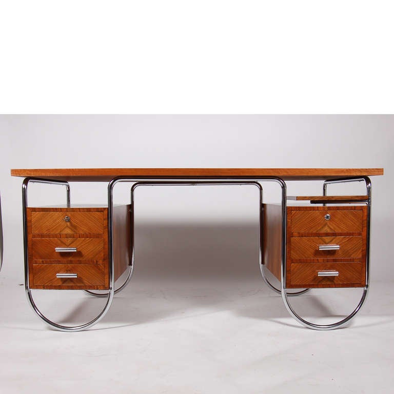 Hard to find double pedestal desk, model 181 E, figured walnut with tubular chrome frame and swing out writing surface. Manufactured by Columbus Tubing Company of Milan, Italy, associates of Embru, Switzerland. Columbus was the premier manufacturer