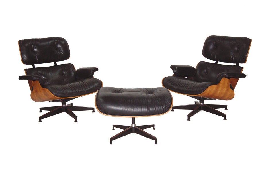 Very nice matched set of two lounges with ottoman; rosewood shells with black leather seating. Good original condition. Retains labels. Made by Herman Miller.
