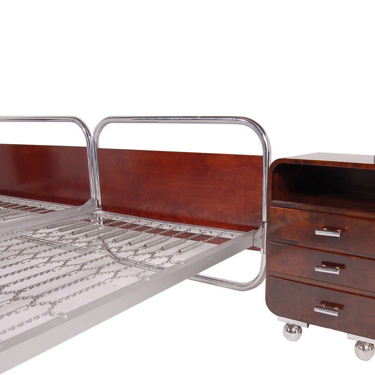 Two single beds, BT91, with tubular polished chrome head and footboards with inset mahogany stained plywood boards on chrome ball feet. Spring mattress platform. 
Measurements: 
Beds (outside measurement): 77.5