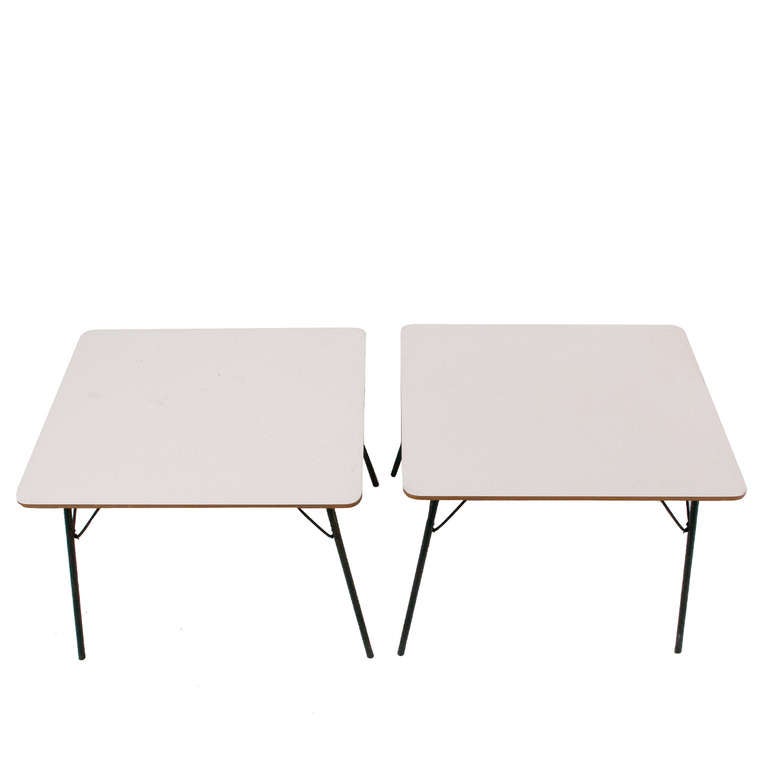 Pair of white laminate top, rare folding leg child's size tables. Can be used for side tables as well. Black painted metal folding legs. All original condition. Manufacturing Herman Miller.