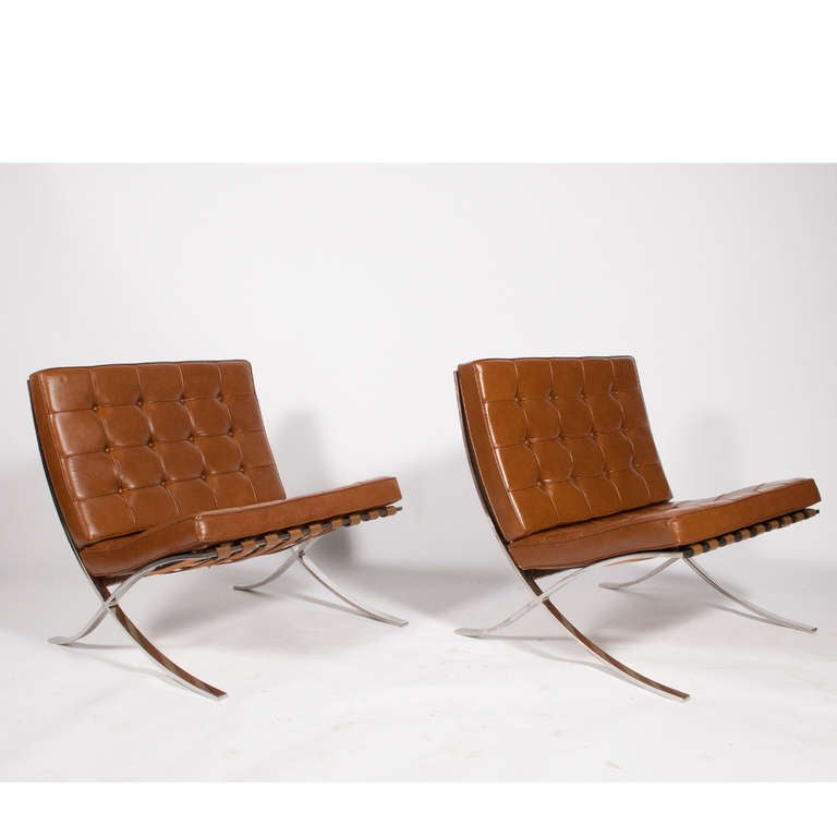 Nicely patinated pair of dark tan leather Barcelona chairs on stainless steel frames. Both retain Knoll labels . Purchased in early 1970's by Knoll employee at Dallas showroom. Designed by Mies van der Rohe.