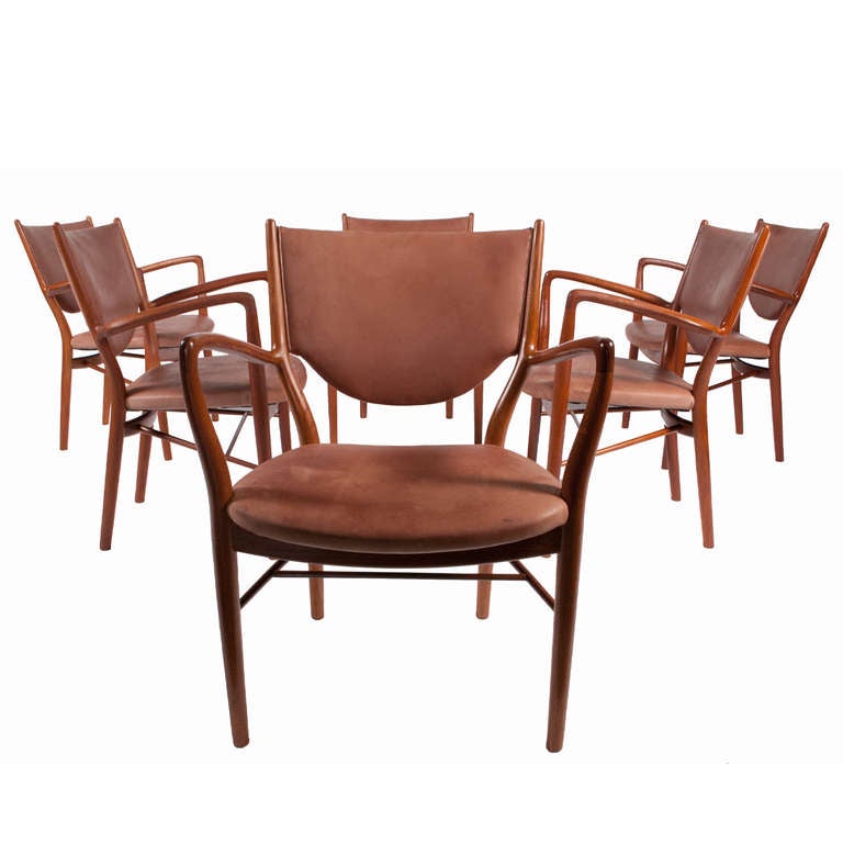 Six solid teak armchairs, with patinated tan leather.  Rarely seen Vodder pieces, handmade with curving and sloping arms.  One of Juhl's finest designs.
Burn marked on stretchers, Niels Vodder Cabinetmaker, Copenhagen Denmark, Design Finn Juhl.