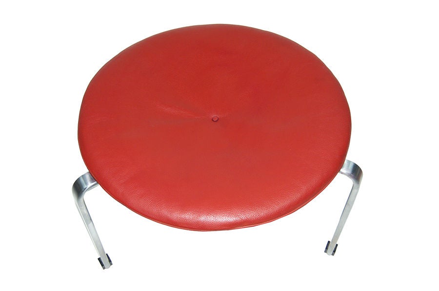 Three leg occasional stool, matte chrome steel base with original leather seat cushion. Made by Fritz Hansen. Marked in frame.