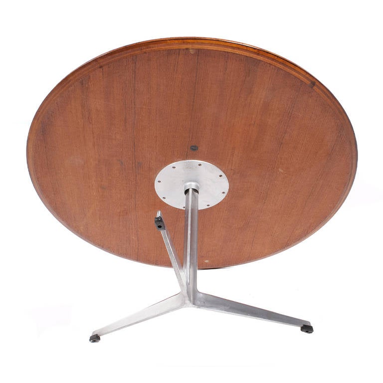 Large size round teak top on aluminum base with three feet. Designed for the SAS Royal Hotel in Copenhagen. Retains Danish control label. Early production. Made by Fritz Hansen.