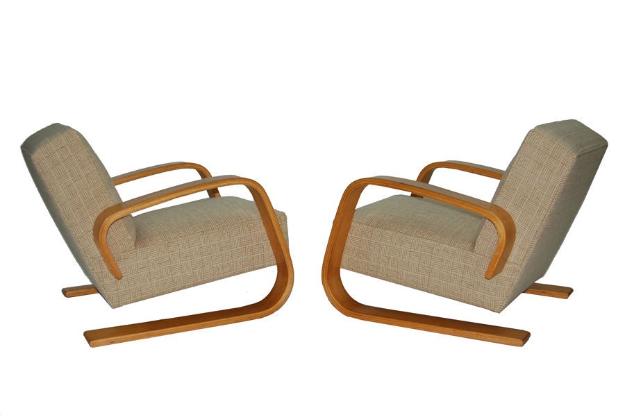 Early pair of model 400 chairs, bent birch plywood arms, with spring construction seat and back. Reupholstered in Knoll Inca wool fabric. Made by Artek.