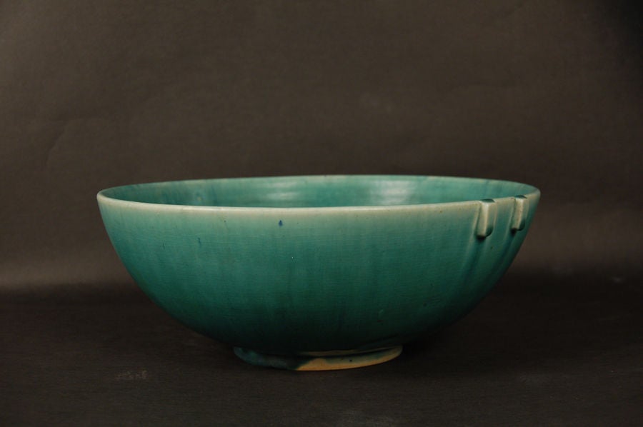 Bowl produced within the first two years of Saxbo's existence, this stoneware bowl is glazed with a green outer color and silver inner mottled glaze. Marked with early Saxbo mark, and artist initials.