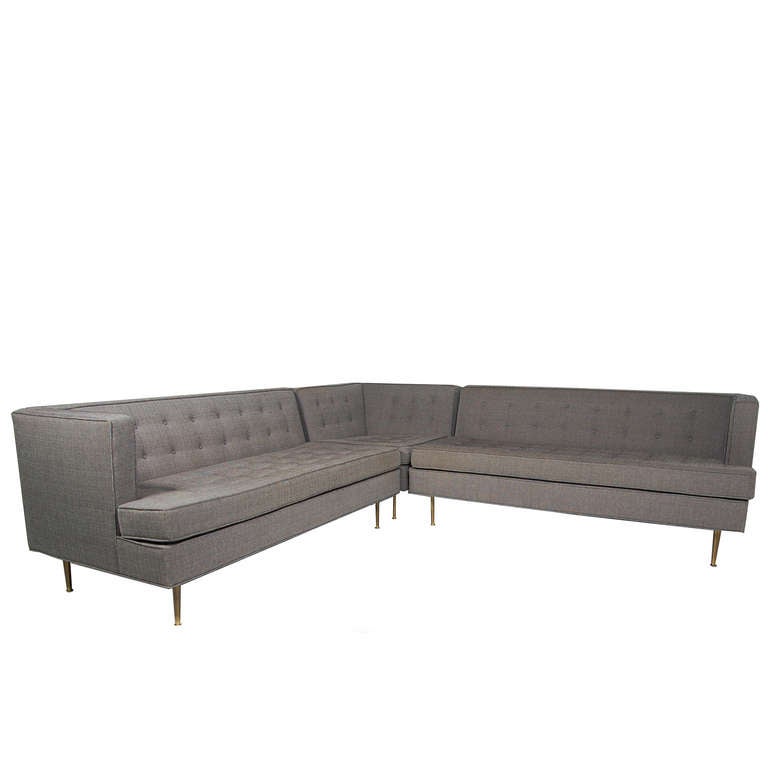 Three section sofa, with button tufted back and seat, on brass legs. Made by Probber Studios.
Two arm pieces measure 60