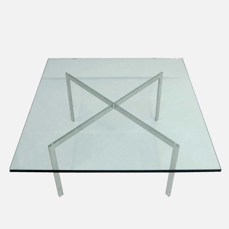 Iconic coffee table, produced by Knoll.  Original glass top on stainless steel x-form base, marked in center with KP, Knoll Products, mark.
