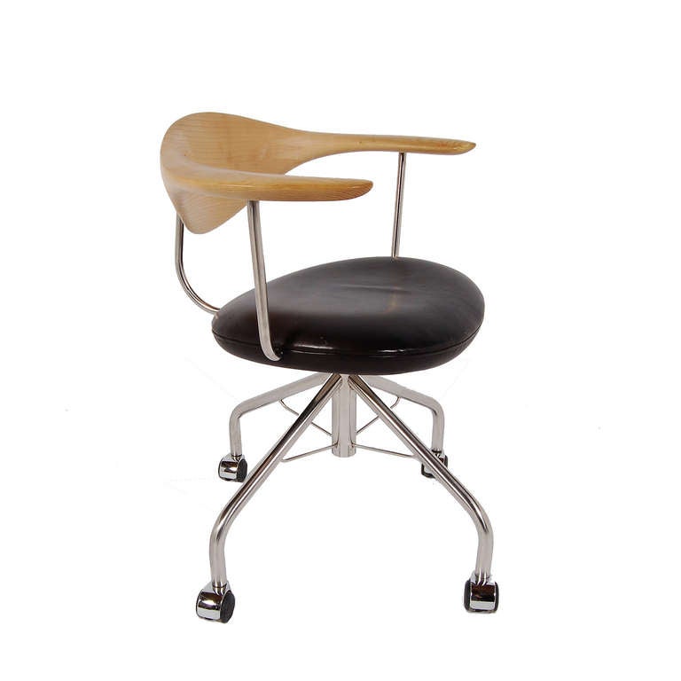 Handmade swiveling desk chair, height adjustable, with solid ash back with finger joint connection. Black leather seat on chrome frame and caster base. Marked and dated. Made by P.P. Mobler.