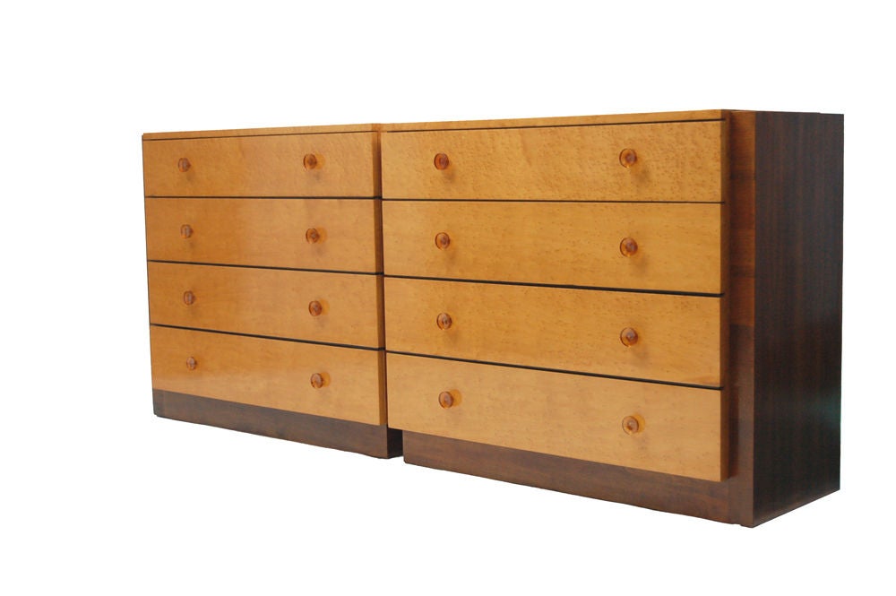 Matched pair of dressers, design numbers 3624 and 3625, white acer (bird's eye maple) with walnut case and original amber lucite drawer pulls. Retains label in drawer. Made by Herman Miller.
