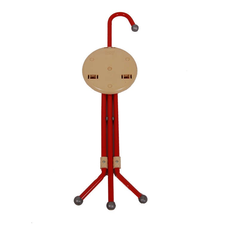 Red painted metal cane shaped frame, folding out to three legs with plastic seat and feet. Made by Sandrigarden, Italy.