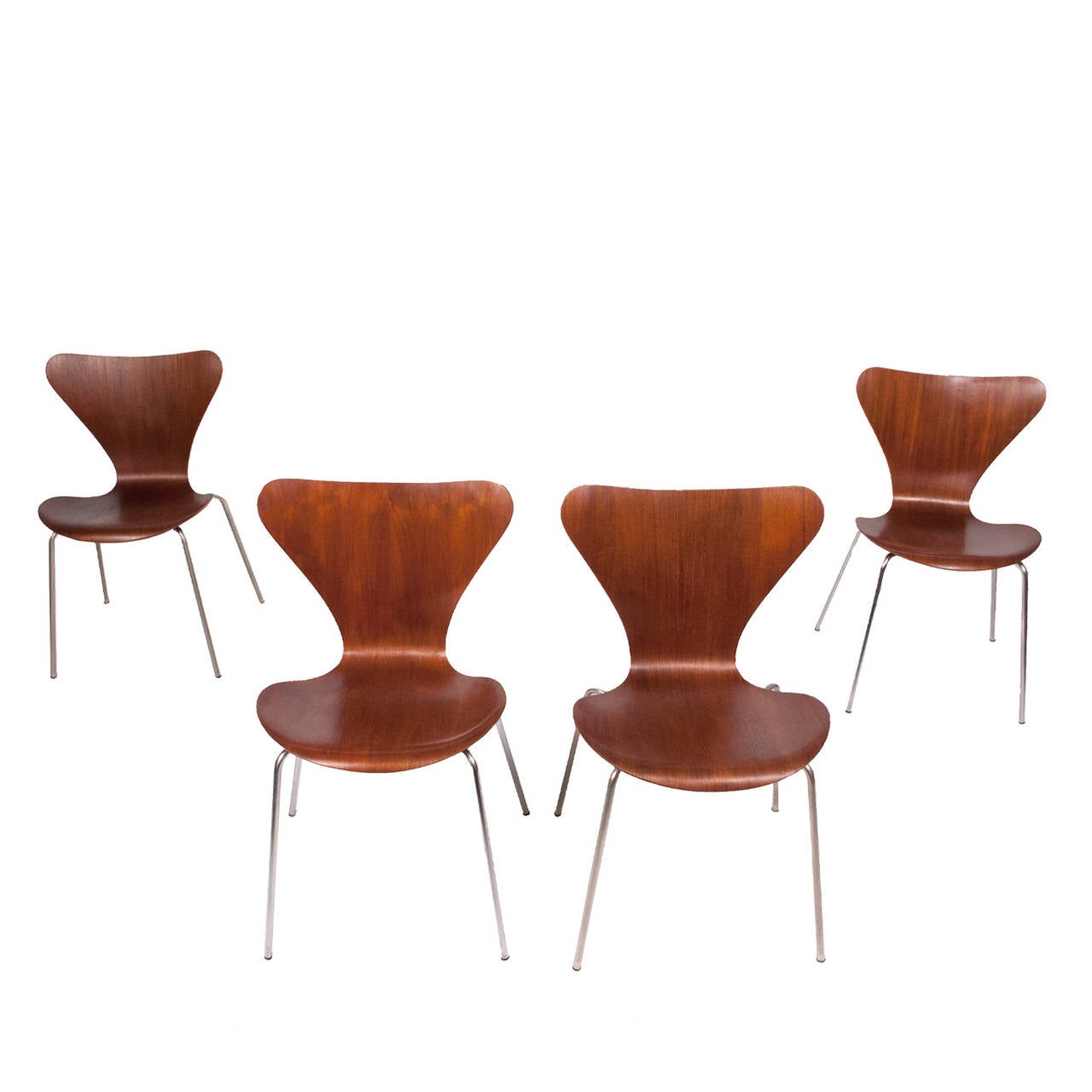 Early production table with teak top on polished chrome steel legs and stretchers, stacking chairs with formed seat in teak on polished chrome legs. All retain glides.
Table with label. Chairs marked on bottom. Table dimensions below.
Made by