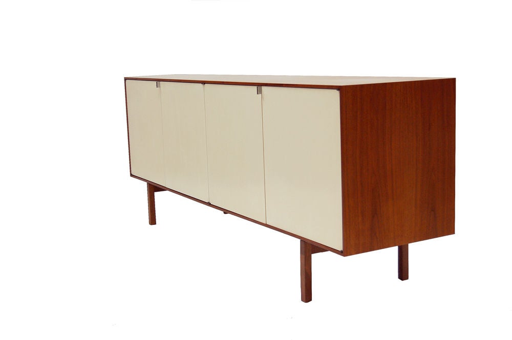 Rare credenza for home use by Knoll; teak case and legs with white lacquered wood doors. Interior drawers have divided interior. Adjustable shelves.  Nice joinery at legs. This credenza won the MOMA Good Design Award in 1950. Made by Knoll