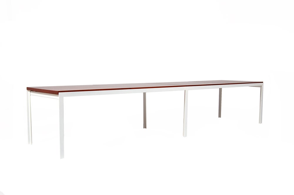 Four section bench with white epoxy finished t-angle steel legs and rosewood stained walnut top.  Can also be used as a coffee table.  Two black wool pillows included. Made by Knoll Associates.